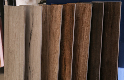 Photo of Samples of different wooden planks in store. Total wholesale