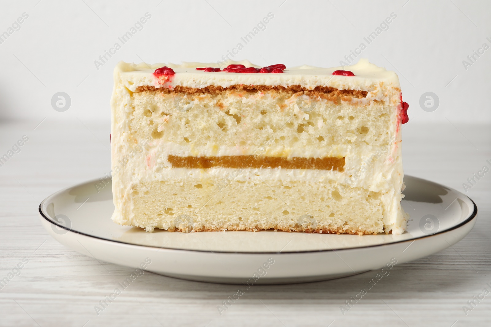 Photo of Cut bento cake on white wooden table, closeup. St. Valentine's day surprise