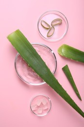 Flat lay composition with aloe vera leaves and cosmetic gel on pink background