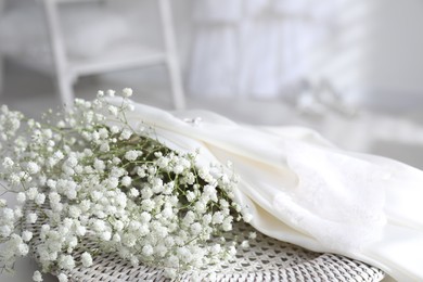 Photo of Wedding dress and flowers indoors, closeup view