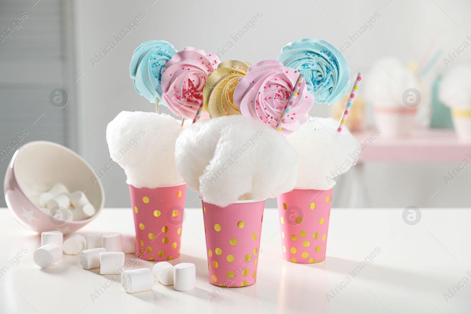 Photo of Cups with cotton candy dessert and marshmallow on table