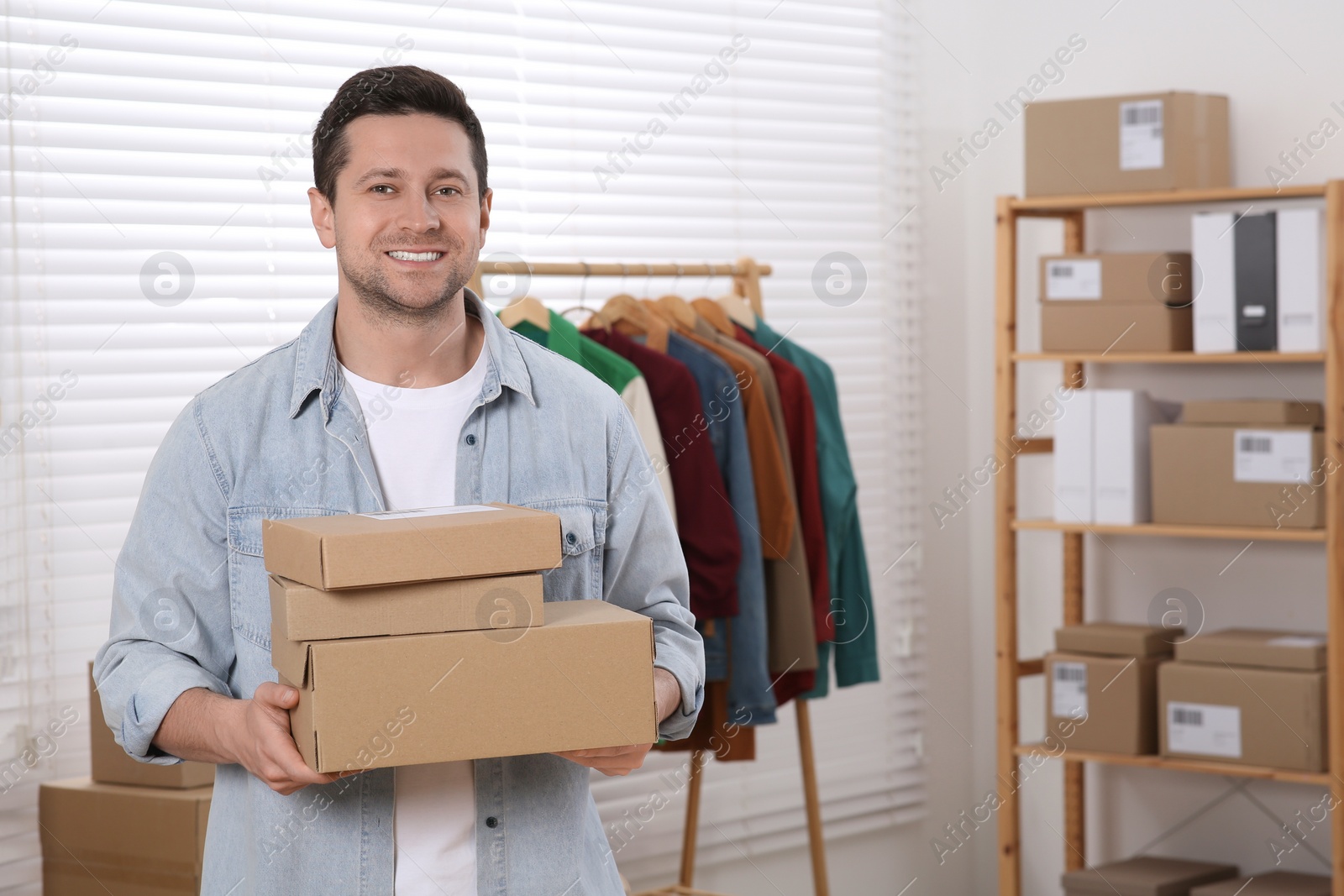 Photo of Seller with parcels in office, space for text. Online store