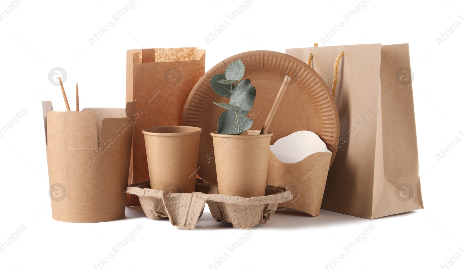 Photo of Eco friendly food packagings, tableware, paper bags and eucalyptus leaves isolated on white