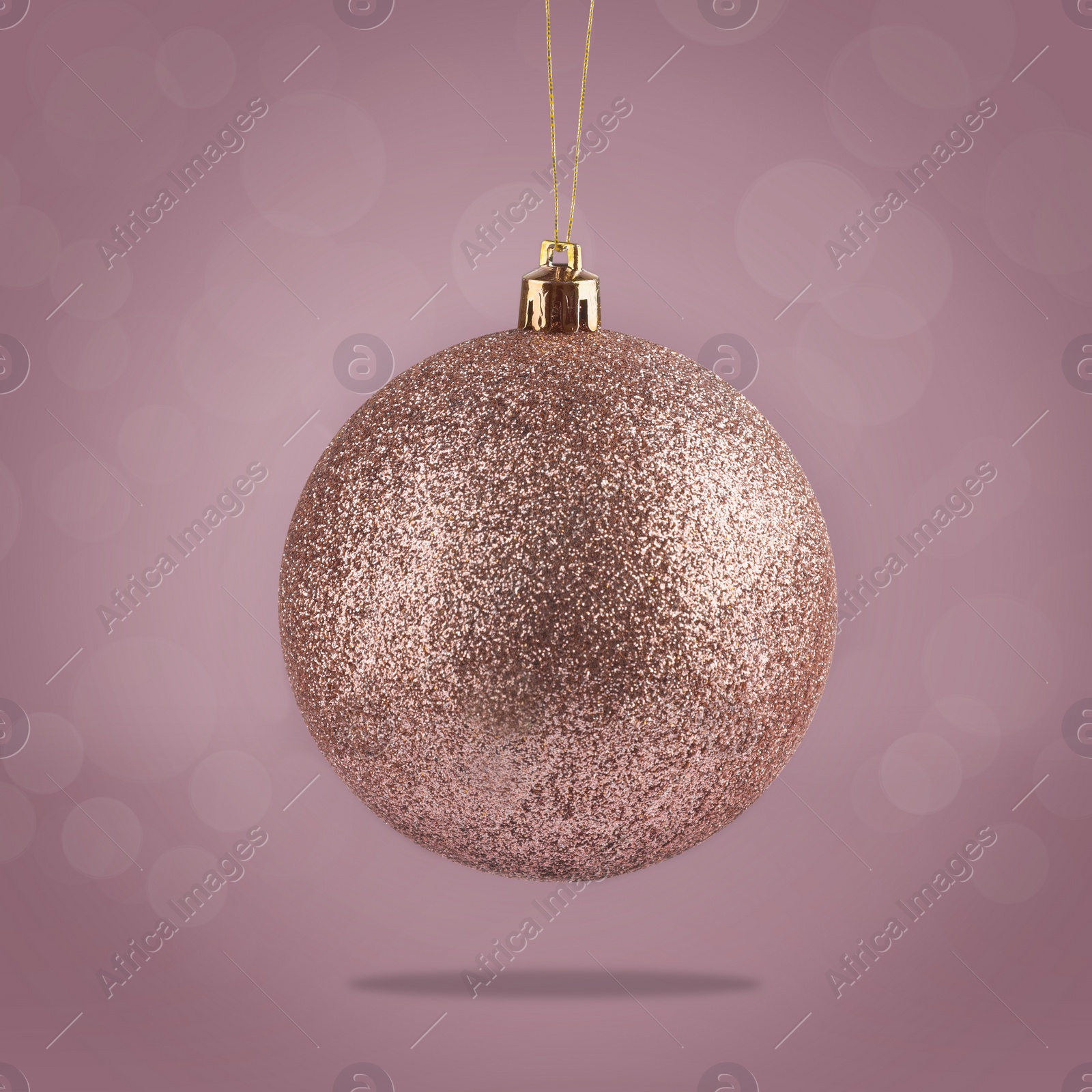 Image of Beautiful glittery Christmas ball hanging on color background