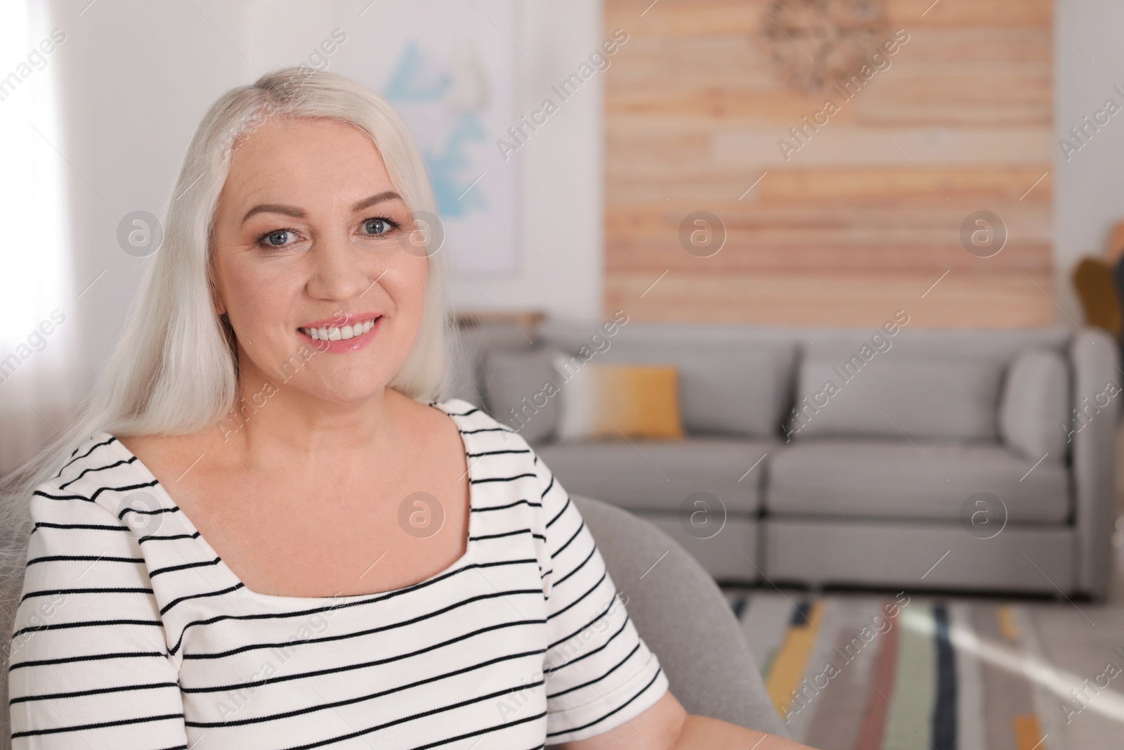 Photo of Portrait of mature woman in living room