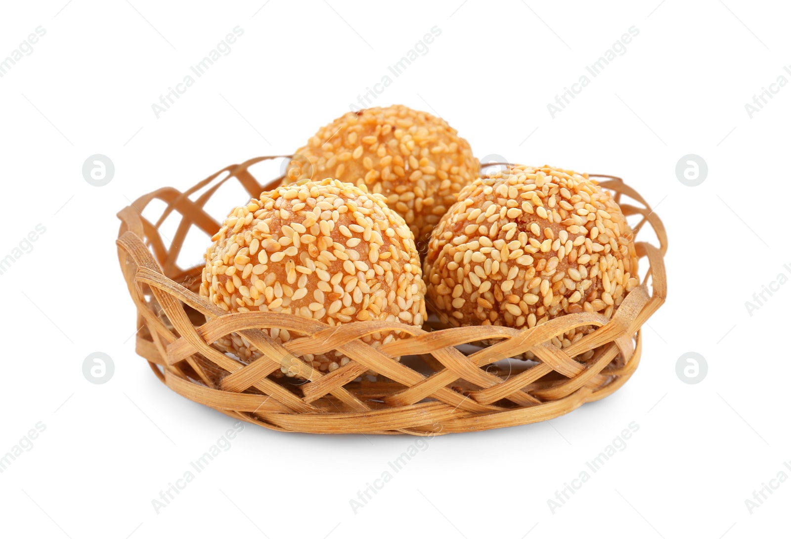 Photo of Wicker basket of delicious sesame balls on white background