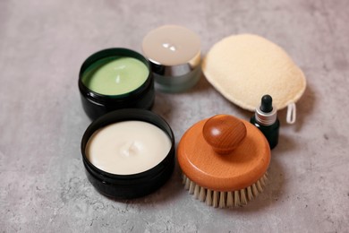 Photo of Natural scrub and other body care products on grey table