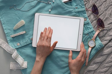 Photo of Woman with modern tablet on light grey background, top view. Space for text
