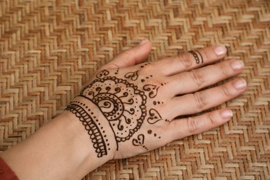 Photo of Woman with beautiful henna tattoo on hand, closeup. Traditional mehndi