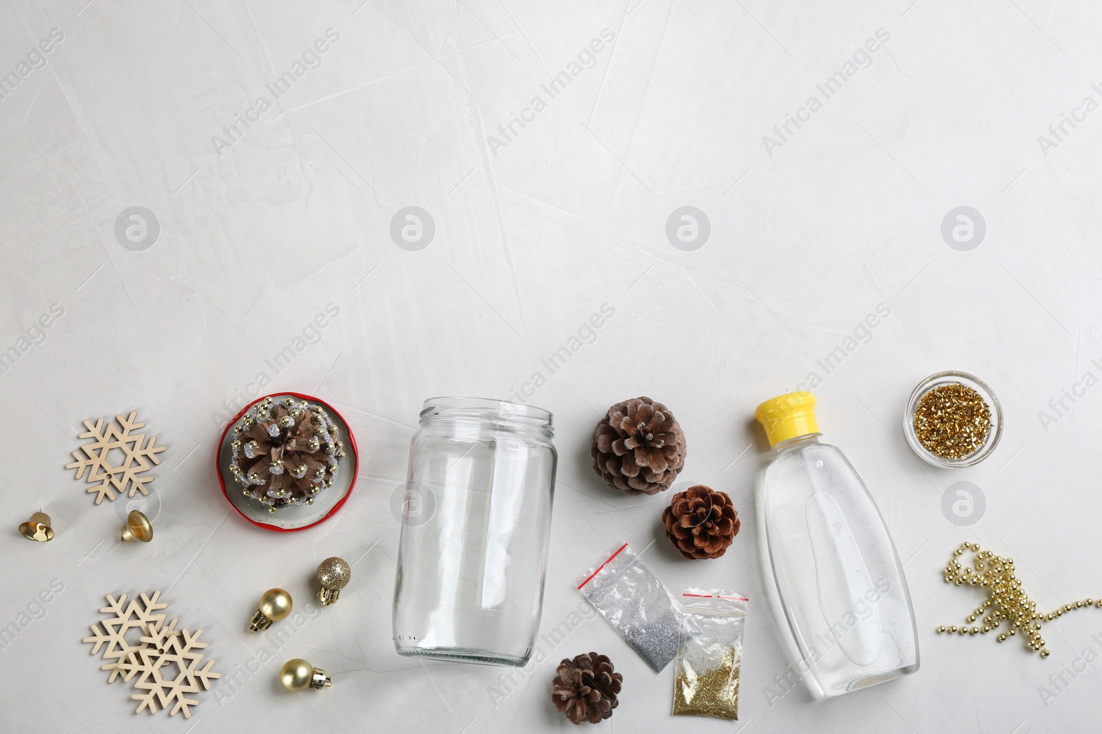 Photo of Materials for handmade snow globe on light table, flat lay. Space for text