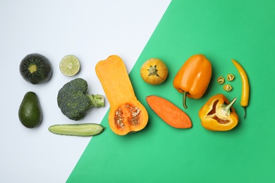 Flat lay composition with fresh ripe vegetables on color background