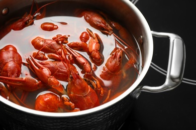Photo of Fresh delicious crayfishes in pot, closeup view