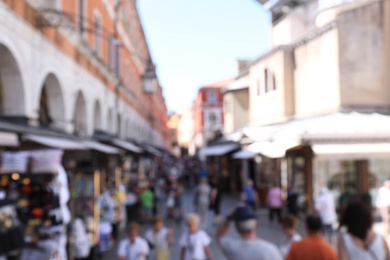 VENICE, ITALY - JUNE 13, 2019: Blurred view of crowded street with souvenir shops