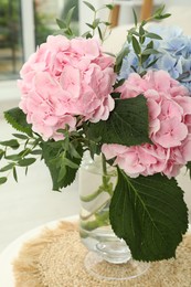 Bouquet with beautiful hortensia flowers on table in living room