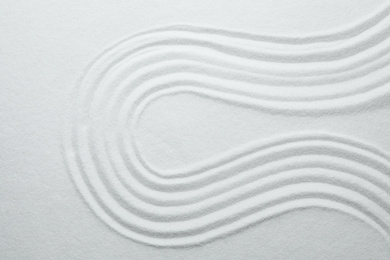 White sand with pattern as background, top view. Zen, meditation, harmony