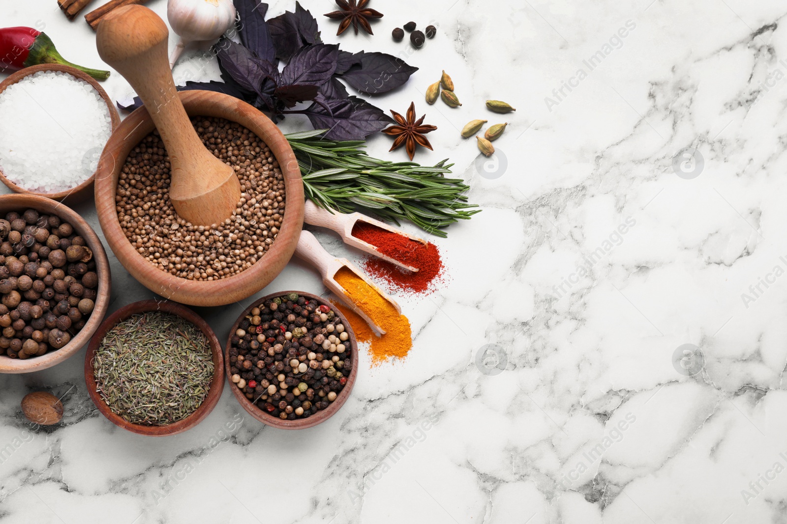 Photo of Flat lay composition with mortar and different spices on white marble table, space for text