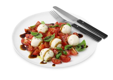 Tasty salad Caprese with tomatoes, mozzarella balls, basil and cutlery on white background