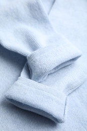 Photo of Warm cashmere sweater as background, closeup view