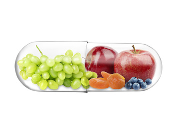 Image of Transparent capsule with different fruits and berries rich in vitamins on white background