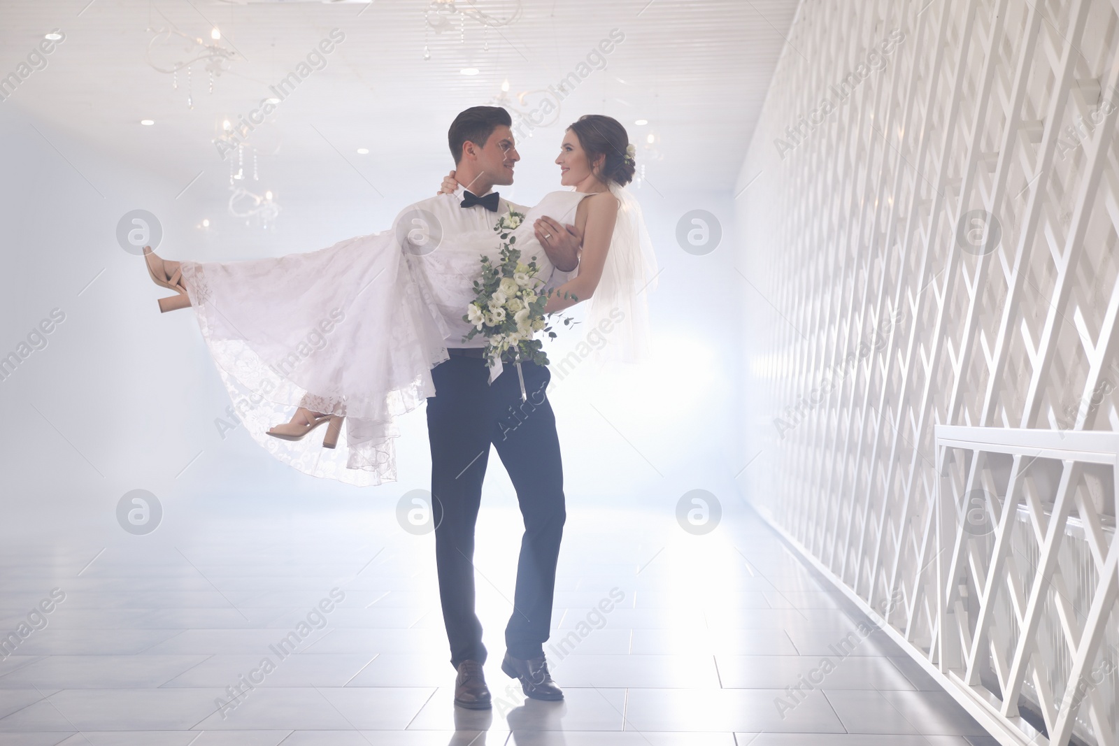 Photo of Happy newlywed couple dancing together in festive hall