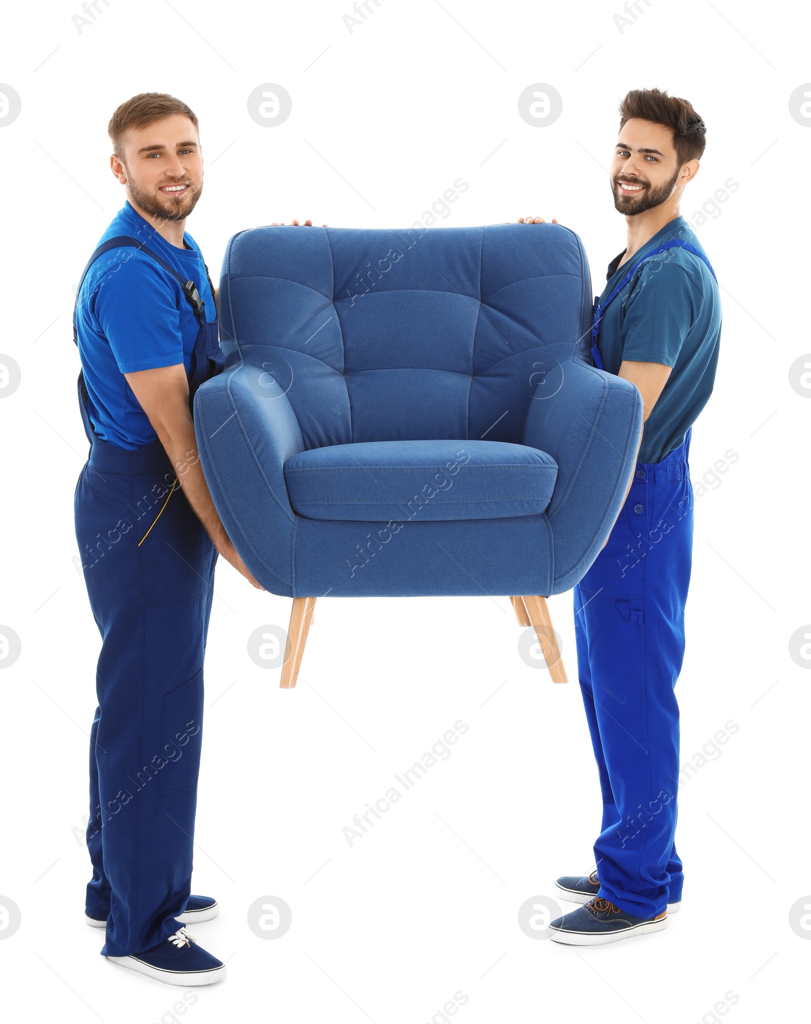 Photo of Young workers carrying armchair isolated on white. Moving service