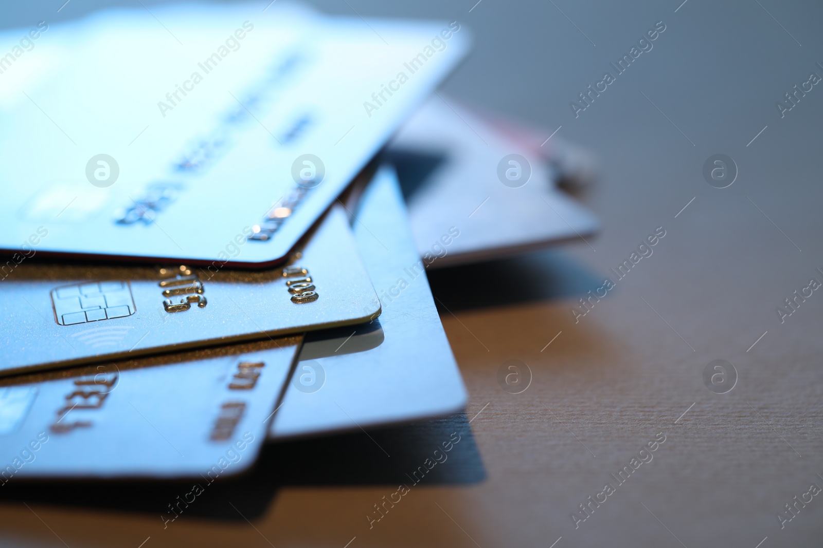 Photo of Many credit cards on gray background, closeup