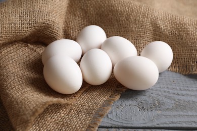 Photo of Fresh chicken eggs on grey wooden table, closeup