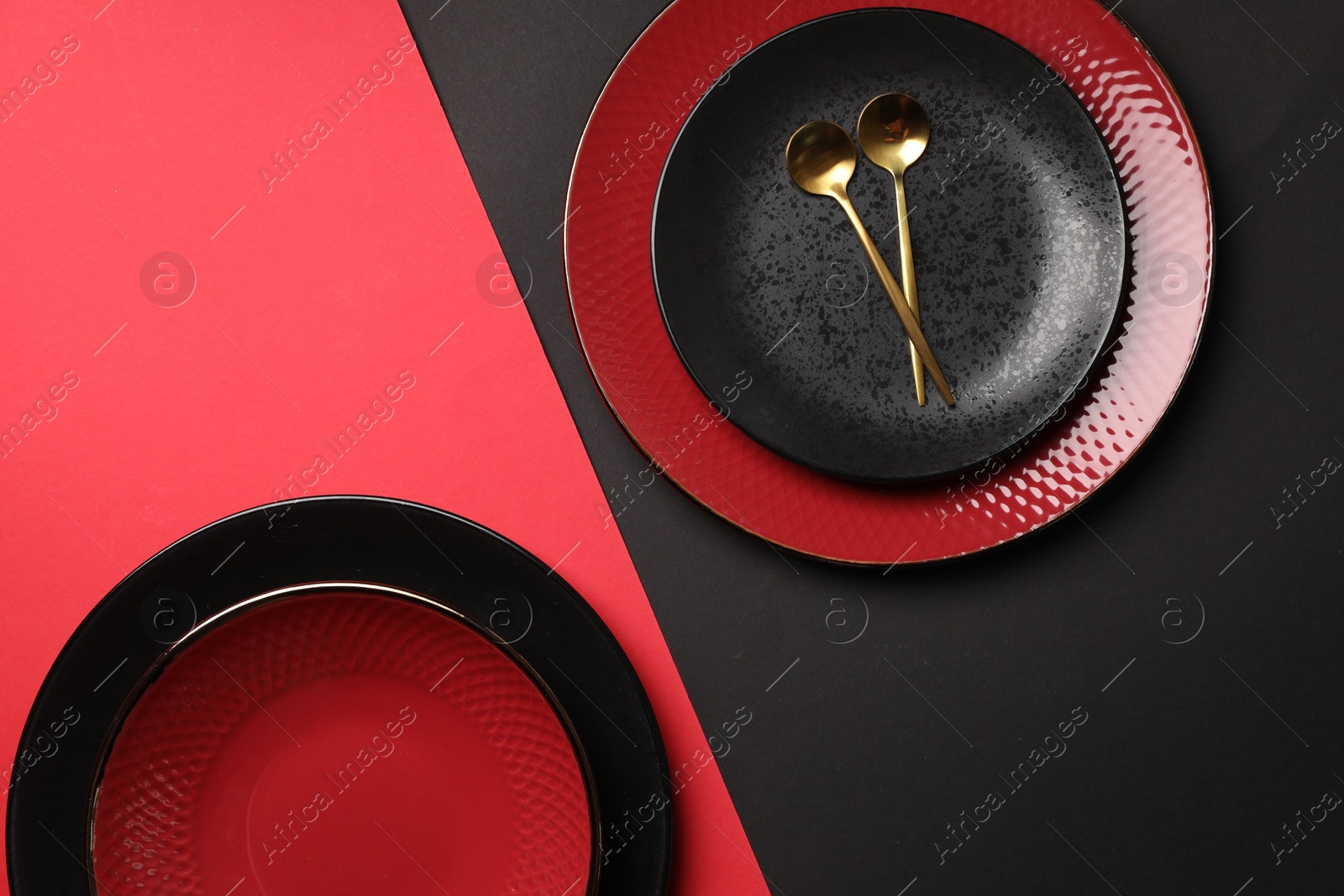 Photo of Stylish table setting with plates and spoons on color background, top view