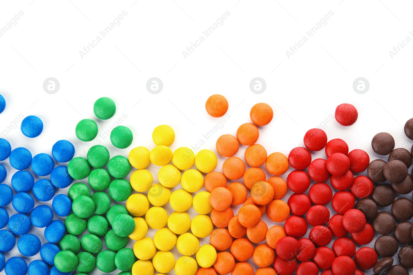 Photo of Tasty colorful candies on white background, top view