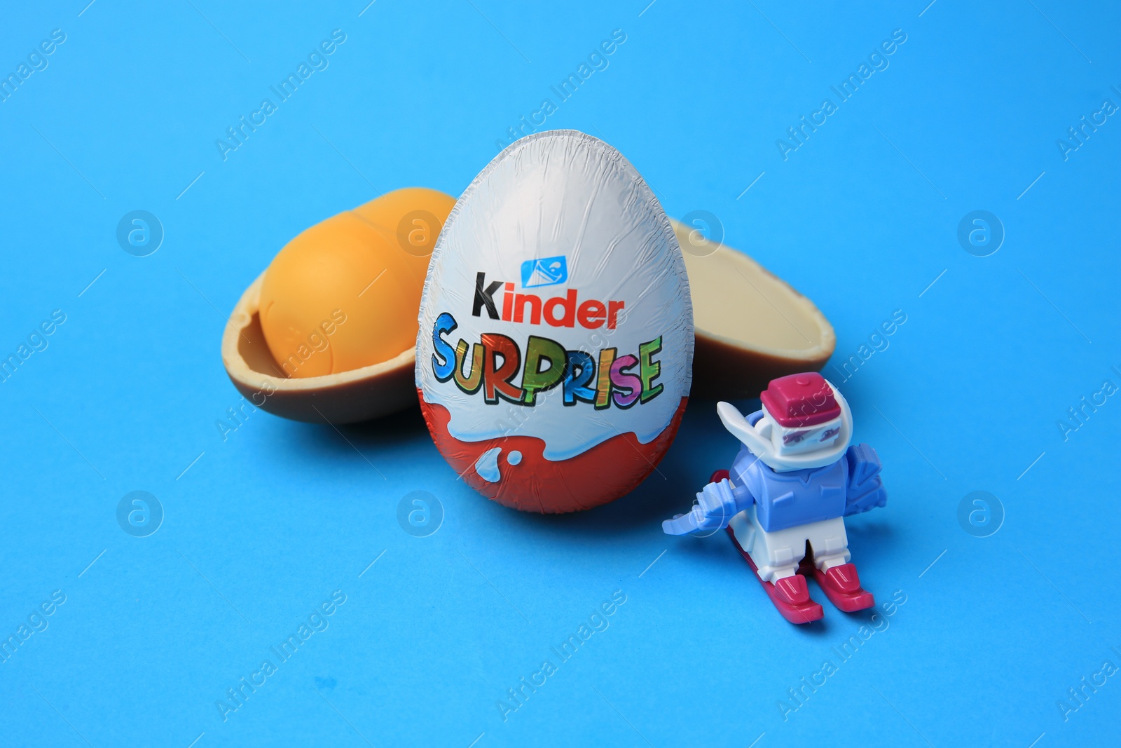 Photo of Sveti Vlas, Bulgaria - June 29, 2023: Kinder Surprise Eggs, plastic capsule and toy on light blue background