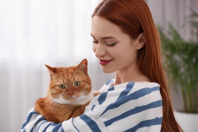 Photo of Woman with her cute cat at home