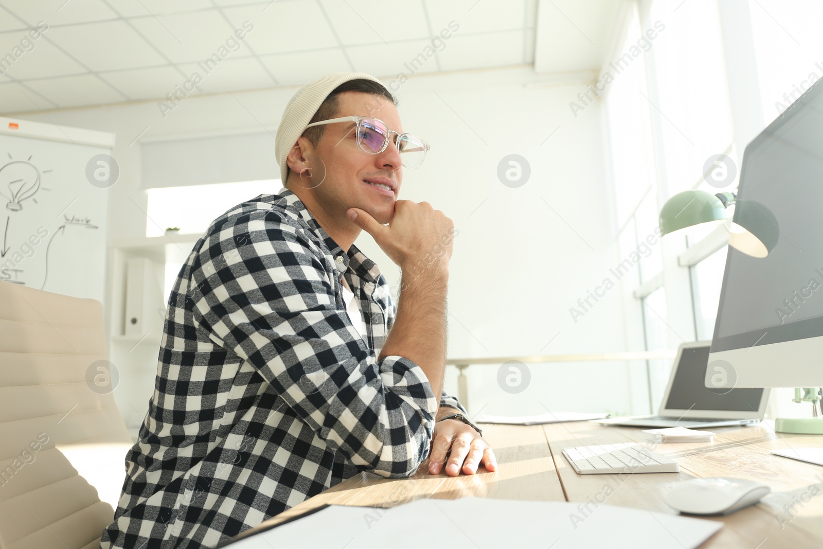 Photo of Freelancer working on computer at table indoors