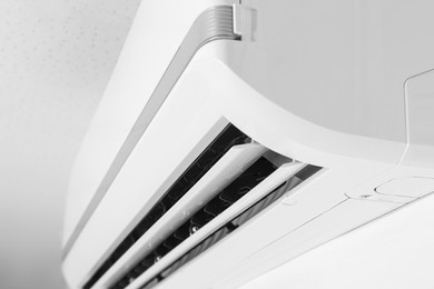 Modern air conditioner on white wall, closeup