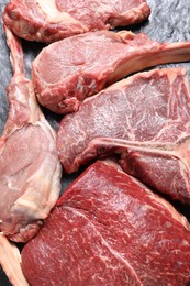 Fresh raw beef cuts on table, above view