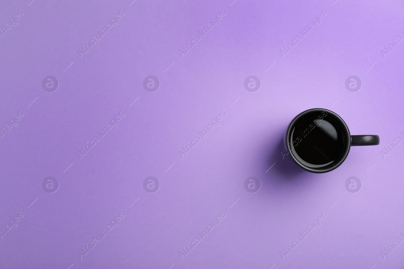 Photo of Ceramic cup with hot aromatic coffee on color background, top view