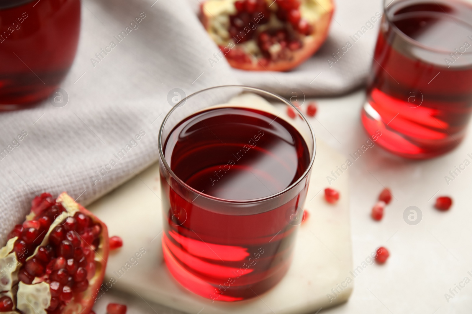 Photo of Freshly made pomegranate juice on light table