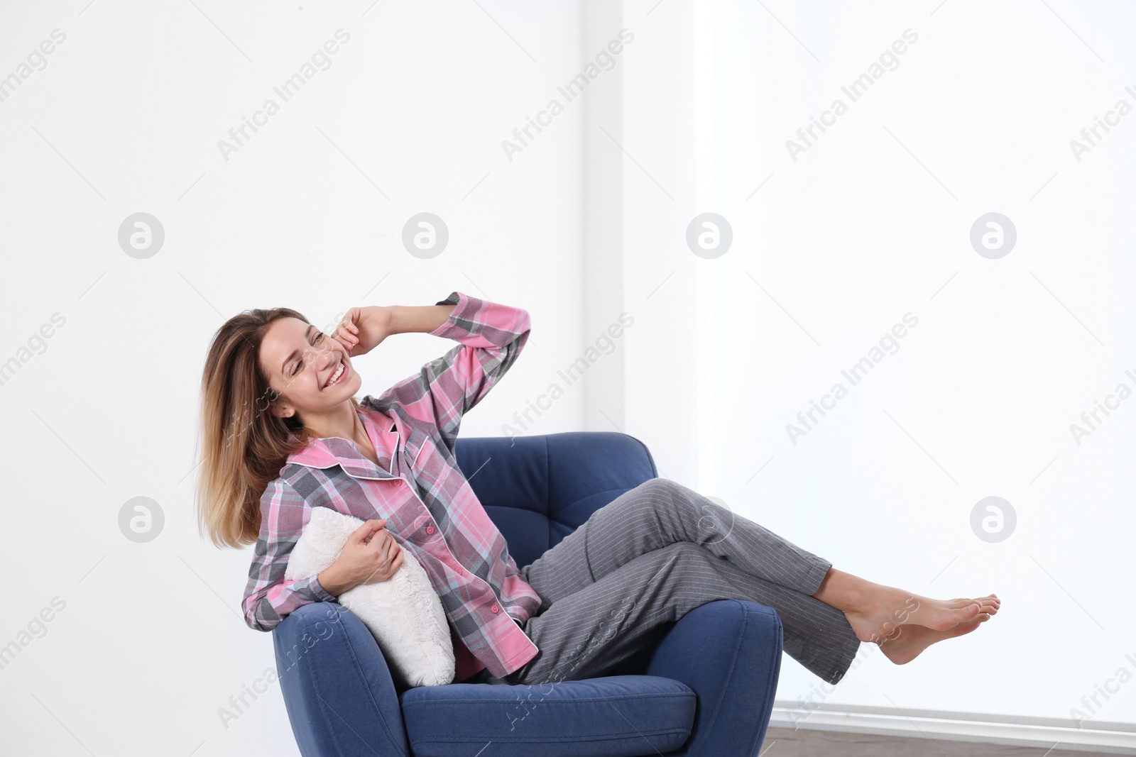 Photo of Young woman relaxing in armchair at home. Space for text