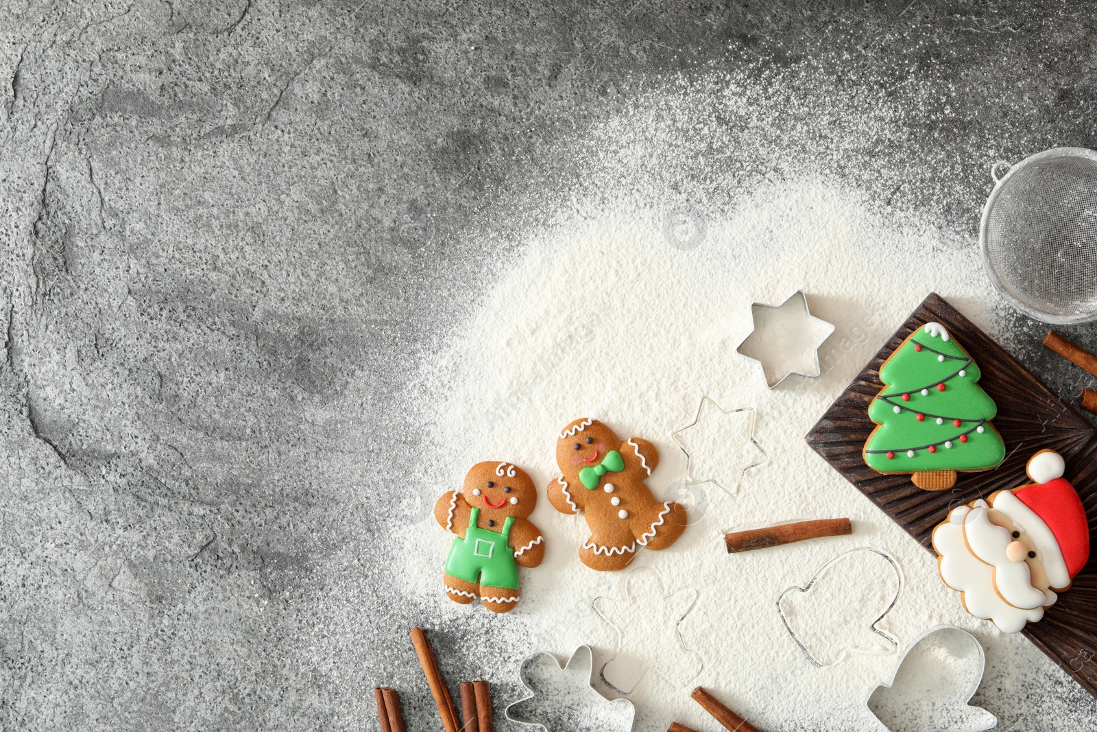 Photo of Flat lay composition with delicious homemade Christmas cookies on grey table. Space for text