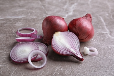 Photo of Ripe red onions on table