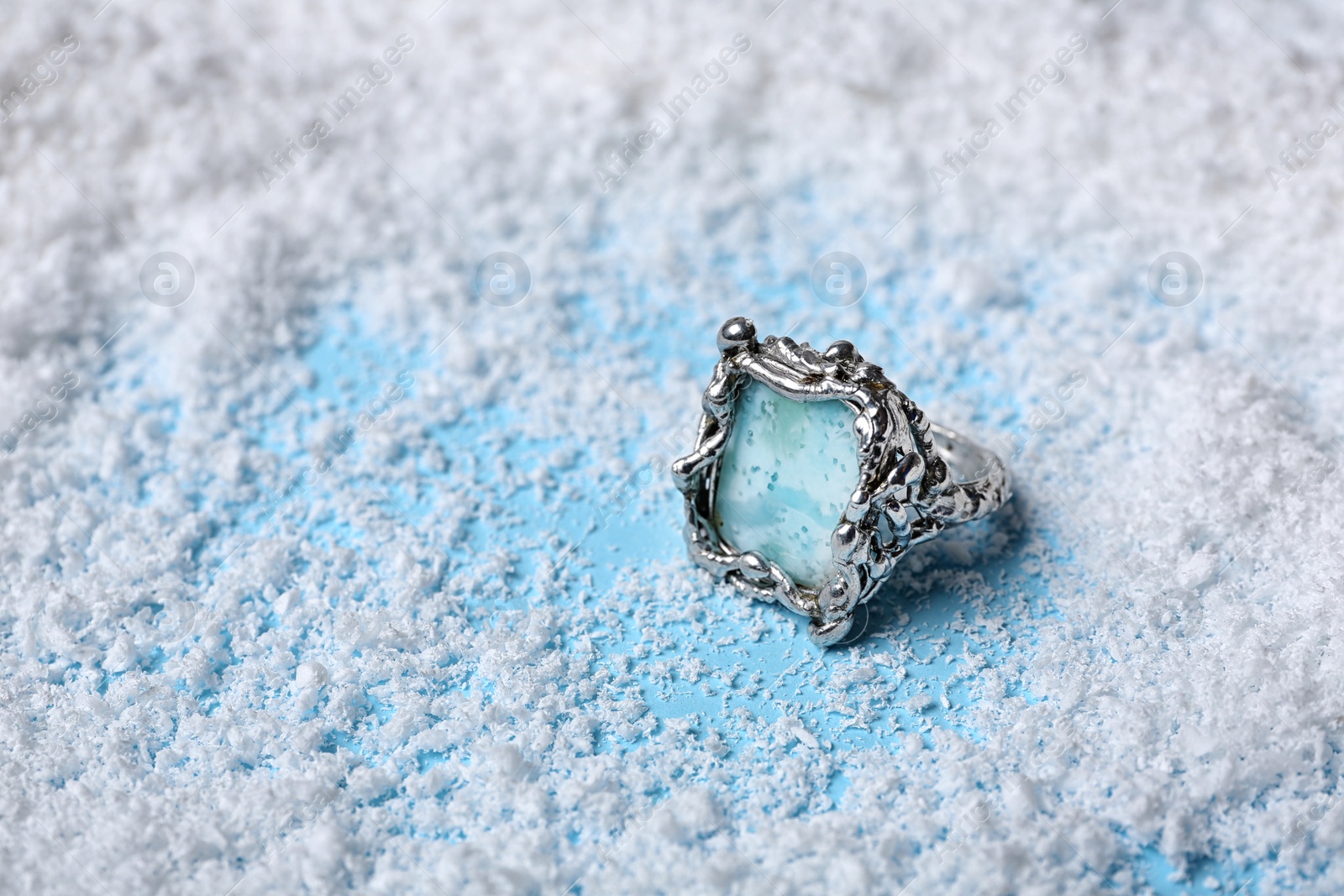 Photo of Beautiful silver ring with larimar gemstone on snow