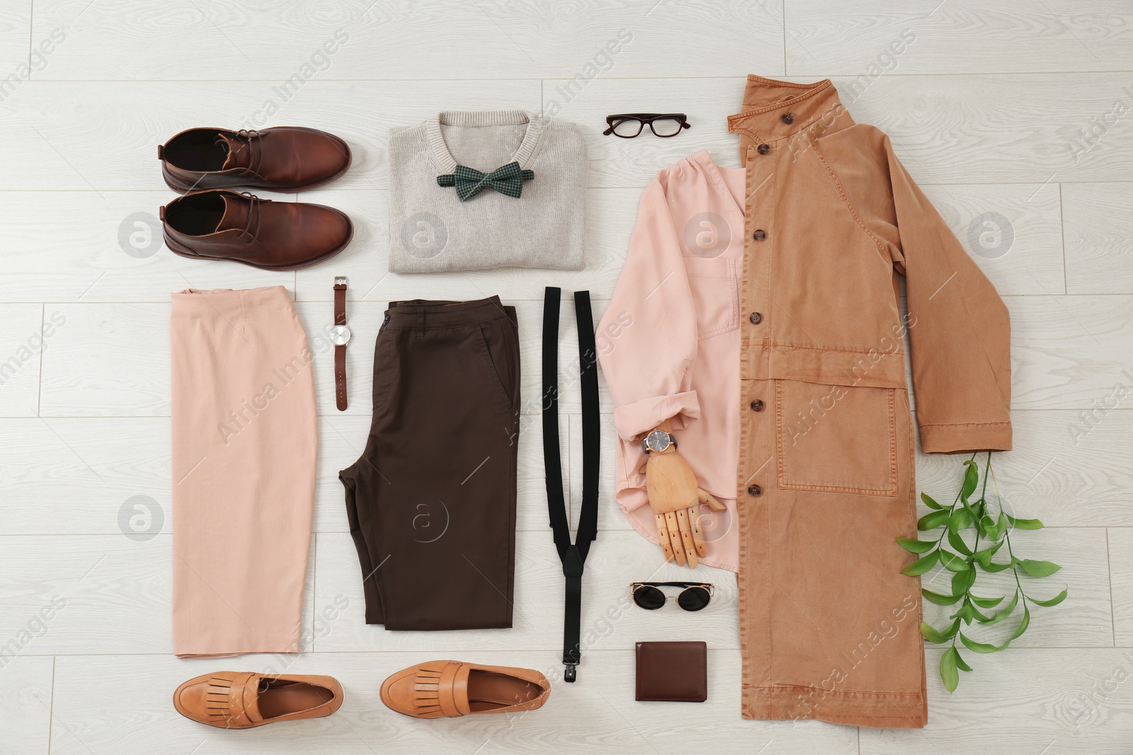 Photo of Flat lay set of stylish clothes and accessories on wooden floor