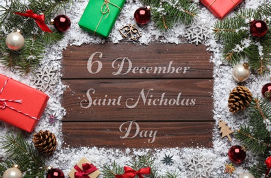 Image of 6 December Saint Nicholas Day. Christmas decorations on wooden background, flat lay