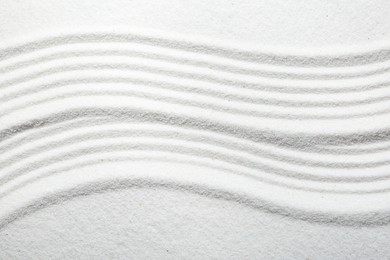 Zen rock garden. Wave pattern on white sand, top view