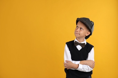 Photo of Cute little detective on yellow background. Space for text