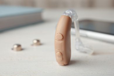 Photo of Hearing aid on table, closeup. Medical device