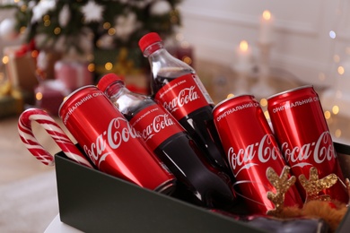 Photo of MYKOLAIV, UKRAINE - JANUARY 13, 2021: Coca-Cola bottles and cans in box, closeup