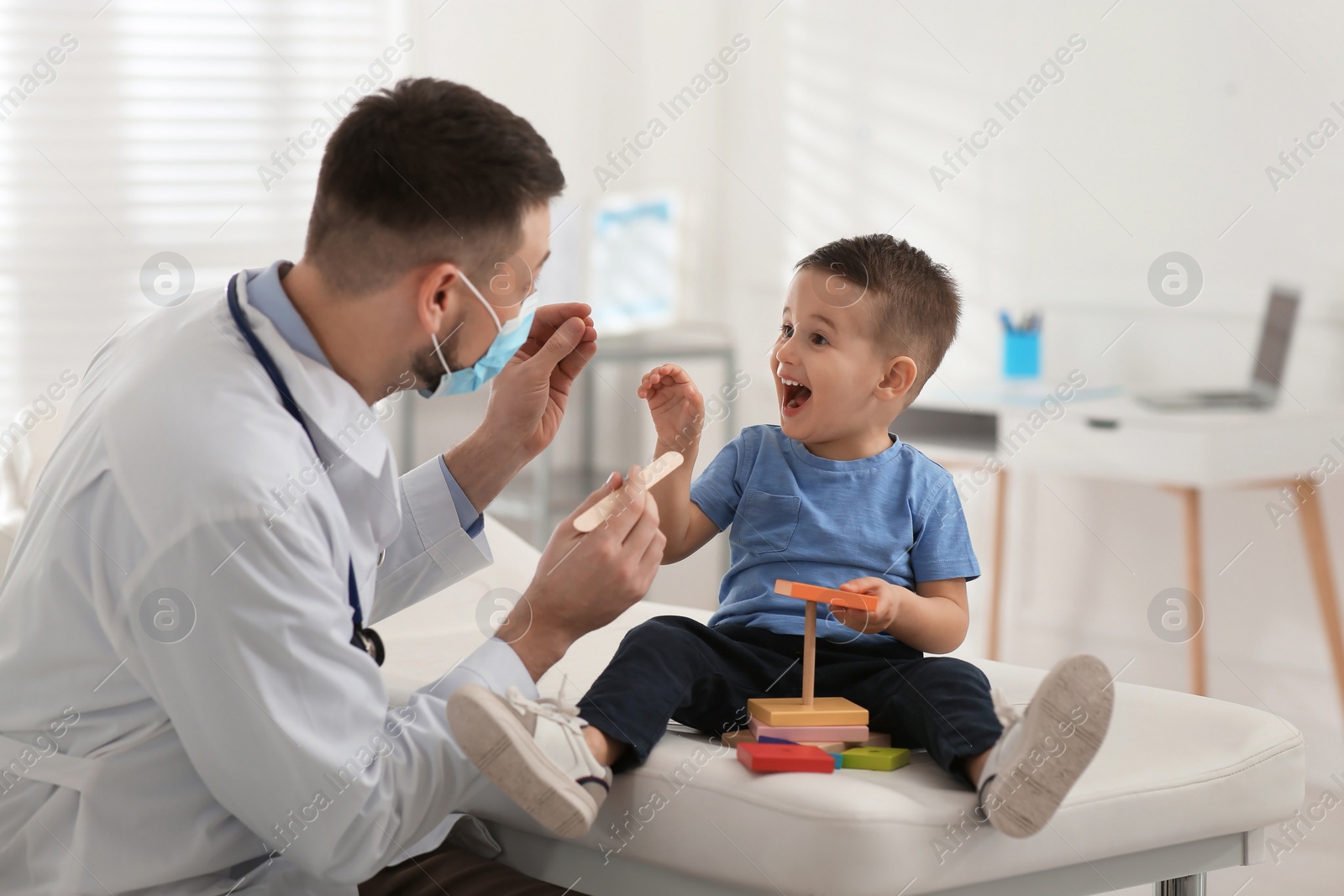 Photo of Pediatrician playing with little boy at hospital