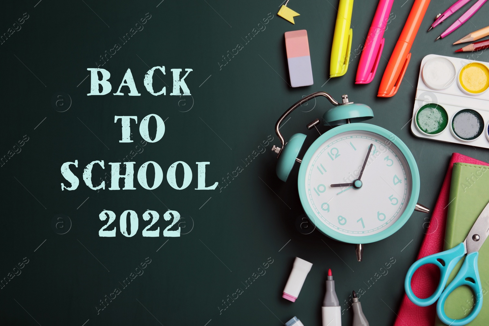 Image of Back to school 2022. Flat lay composition with alarm clock and different stationery on green chalkboard