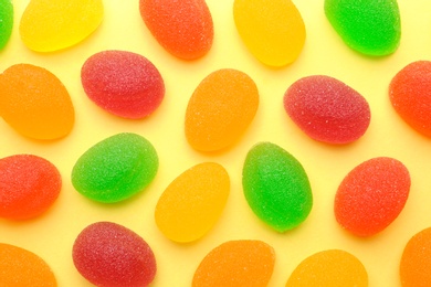 Tasty bright jelly candies on color background, flat lay