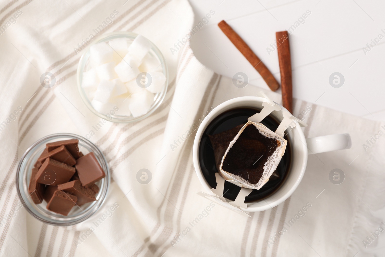 Photo of Flat lay composition with drip coffee in cup on white table